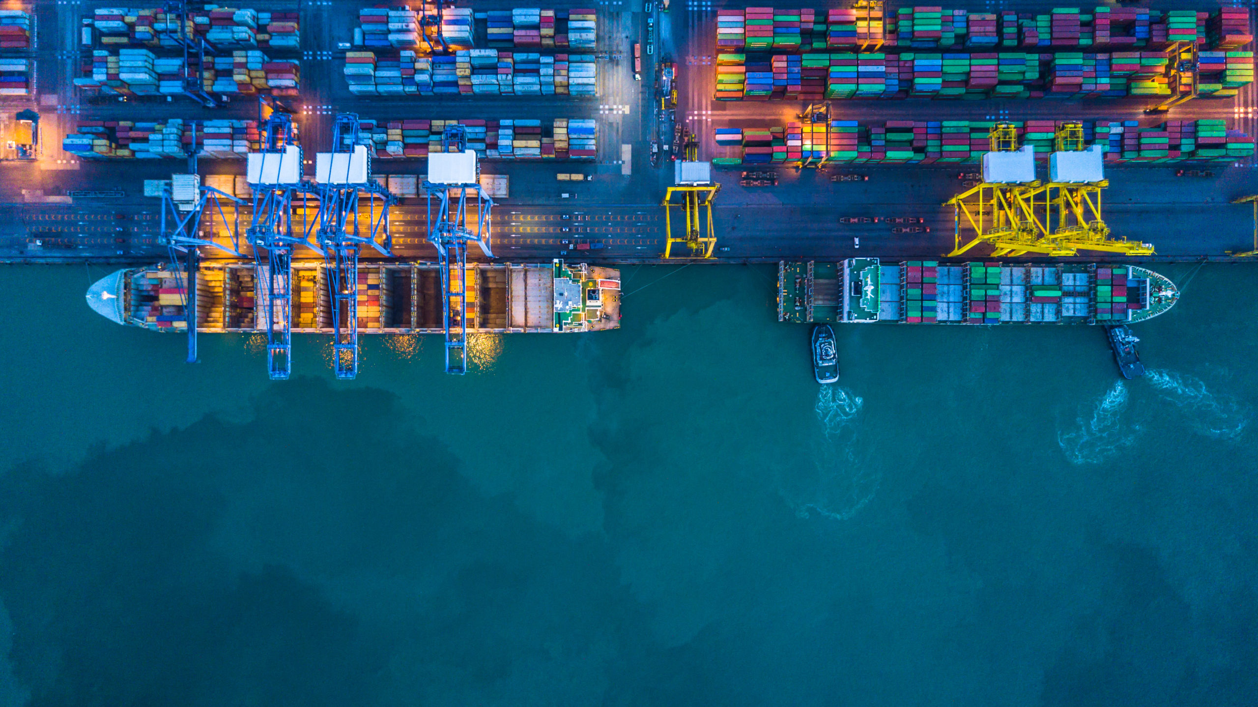 Container,Ship,Loading,And,Unloading,In,Deep,Sea,Port,,Aerial